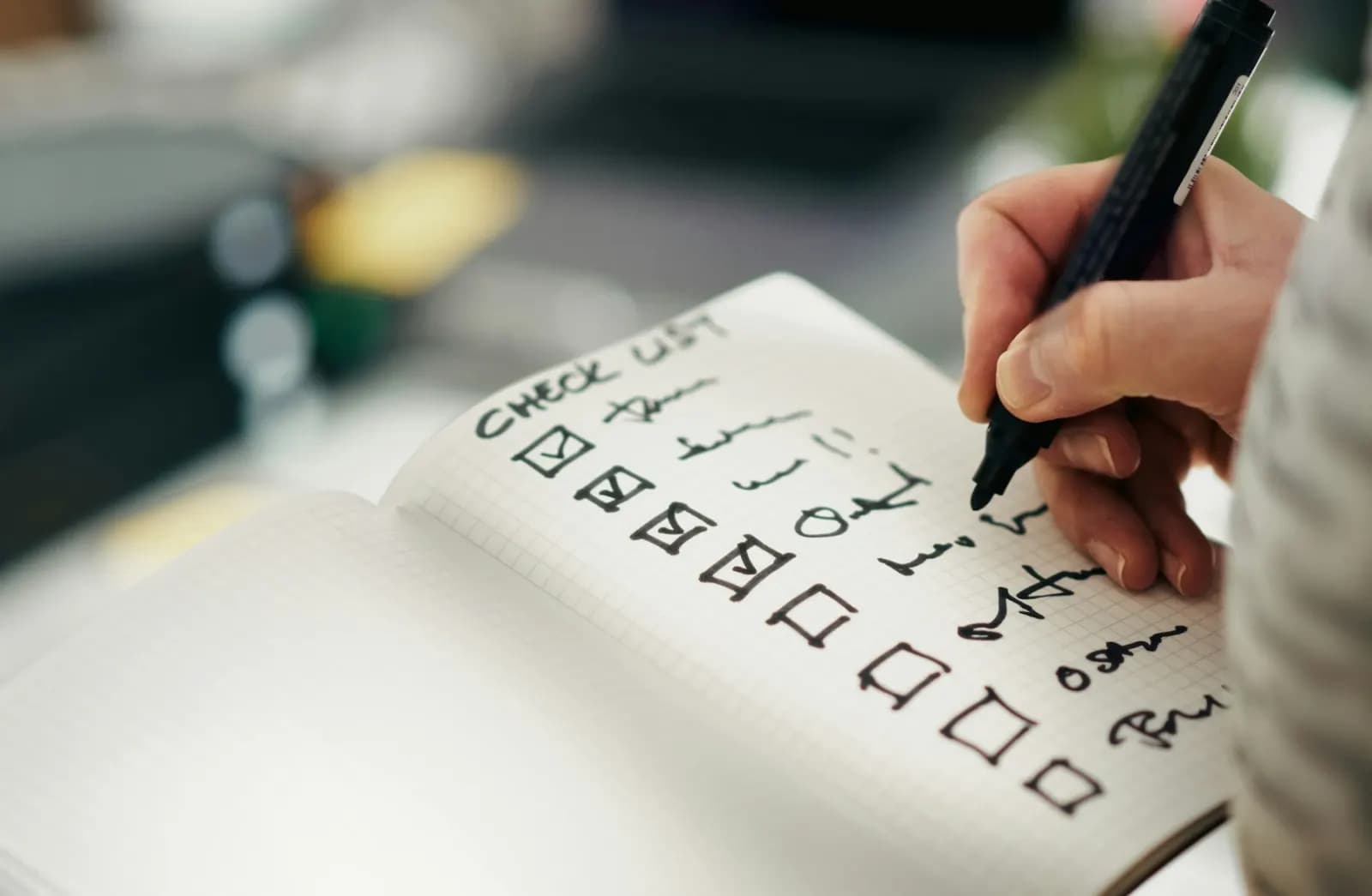 A hand checking items off a checklist