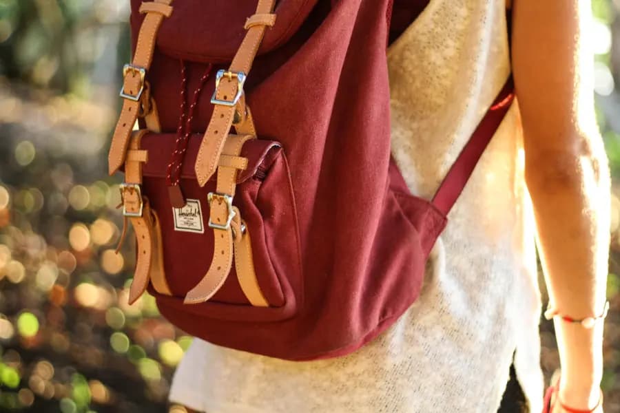 Close-up of a red rucksack being worn outdoors